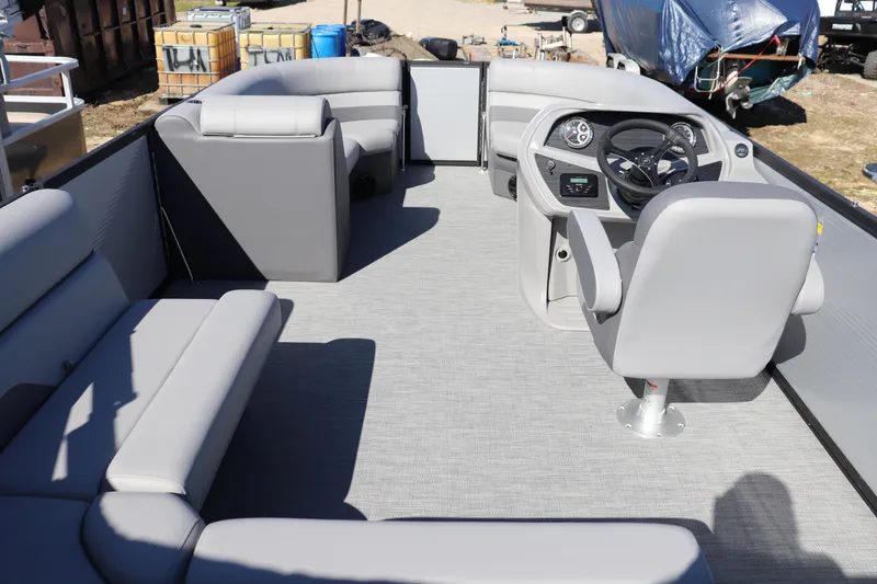 Slide: The Image of 2025 Flagship Freedom 20 LS pontoon boat interior with gray seating and steering console. - 7