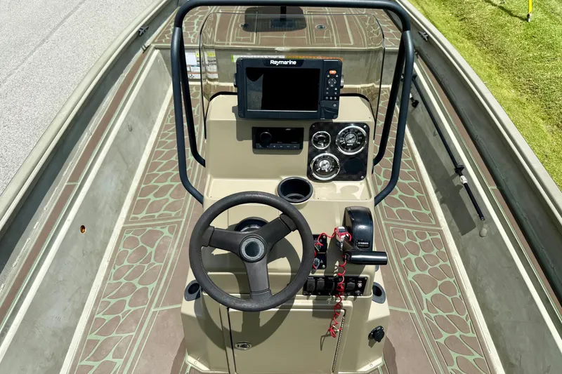 Slide: The Image of 2021 Alumacraft 2072 All Weld MV CC boat console with steering wheel and navigation system. - 10