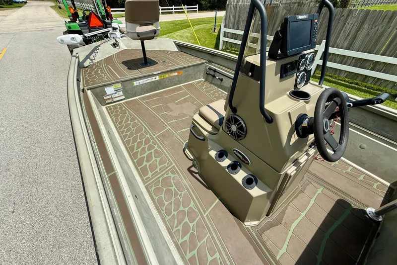 Slide: The Image of 2021 Alumacraft 2072 All Weld MV CC boat interior with steering console and seating. - 11