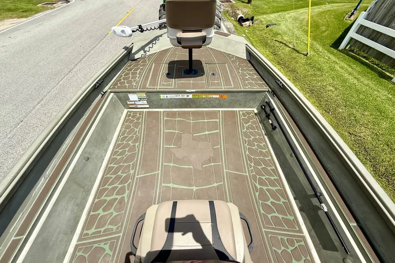 Slide: The Image of 2021 Alumacraft 2072 All Weld MV CC boat interior with patterned flooring and seating. - 12