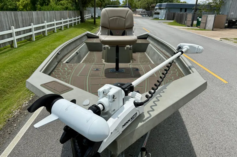 Slide: The Image of 2021 Alumacraft 2072 All Weld MV CC boat with Minn Kota trolling motor on a road. - 6