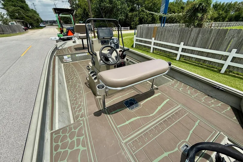 Slide: The Image of 2021 Alumacraft 2072 All Weld MV CC boat with console and seating on a sunny day. - 8