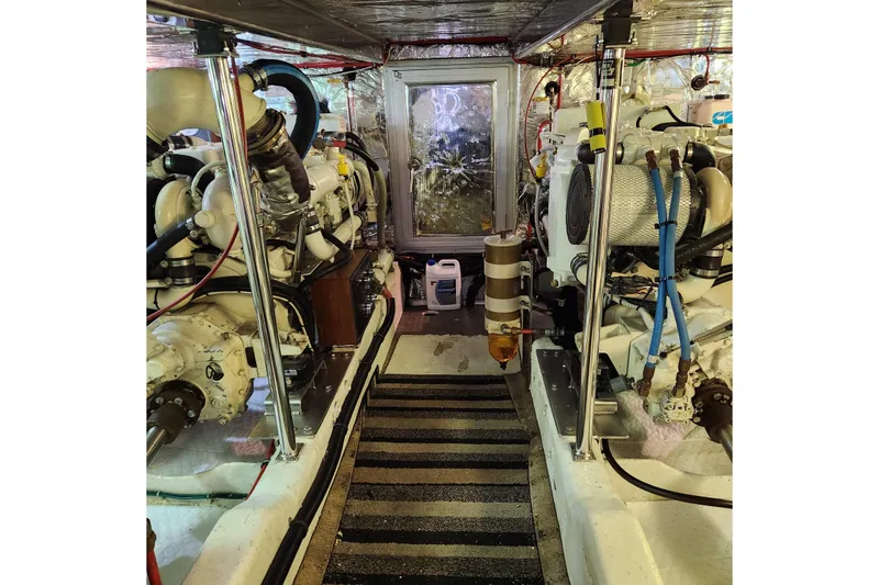 Slide: The Image of Engine room of 2001 Ocean Alexander Classico yacht, showcasing dual engines and equipment. - 104