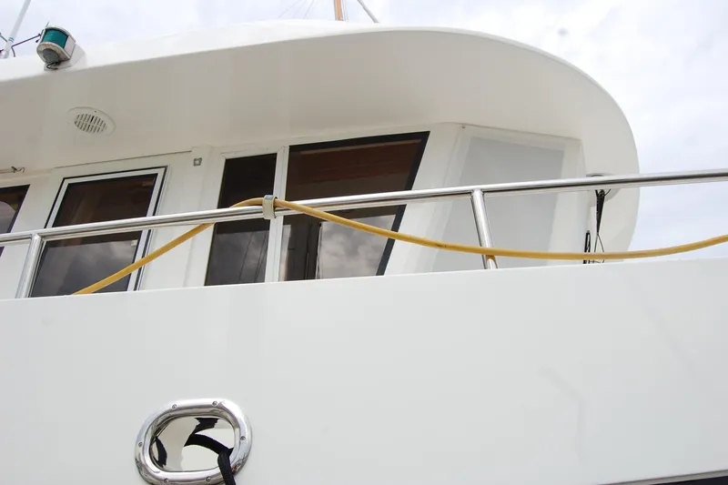 Slide: The Image of 2001 Ocean Alexander Classico yacht exterior with railing and windows. - 12