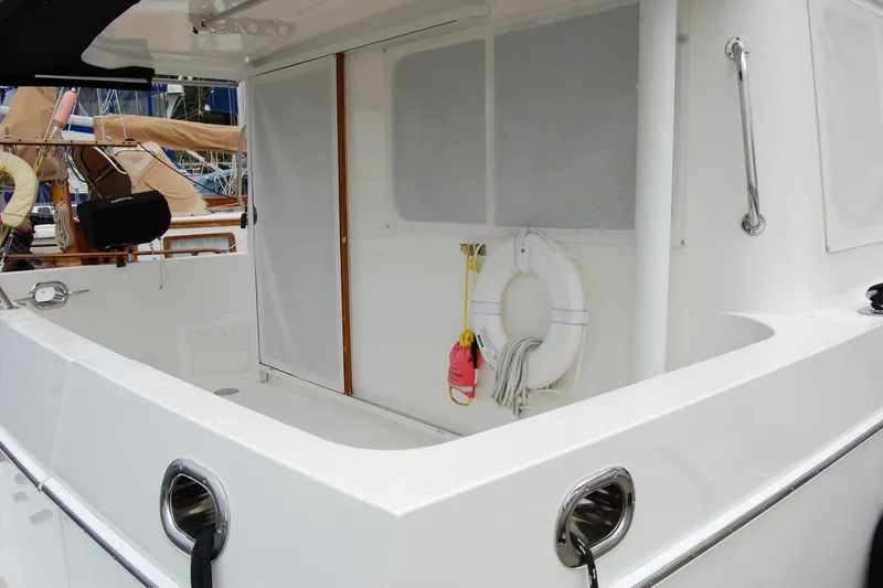 Slide: The Image of 2001 Ocean Alexander Classico yacht deck with safety equipment and sleek design. - 13