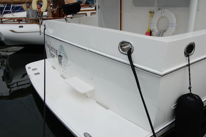 Slide: The Image of 2001 Ocean Alexander Classico yacht stern view with dock lines and fender. - 15