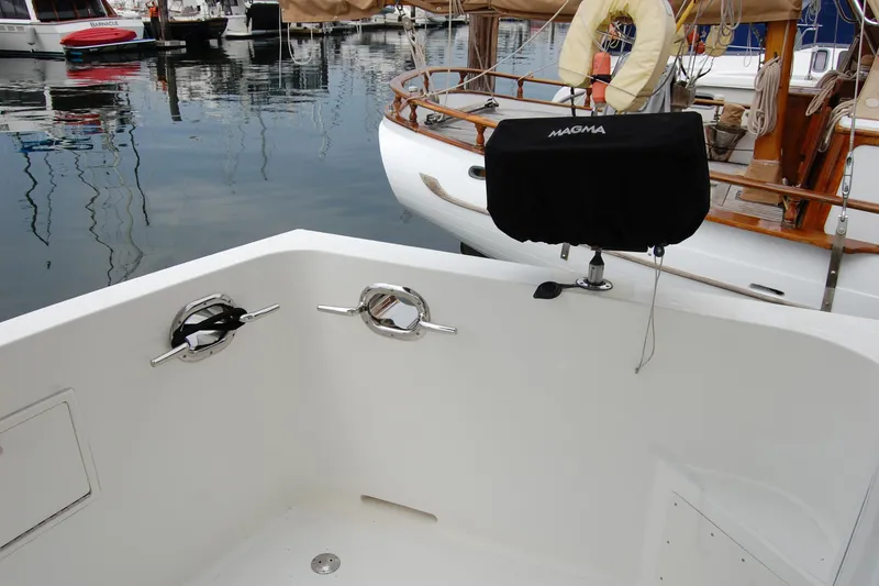 Slide: The Image of Cockpit view of 2001 Ocean Alexander Classico yacht with docked boats in background. - 16