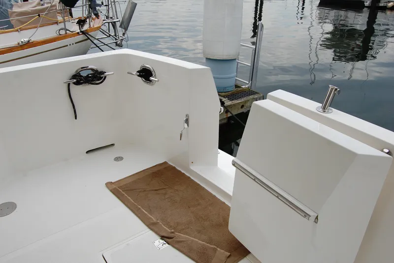 Slide: The Image of 2001 Ocean Alexander Classico yacht deck with mooring cleats and water reflections. - 17