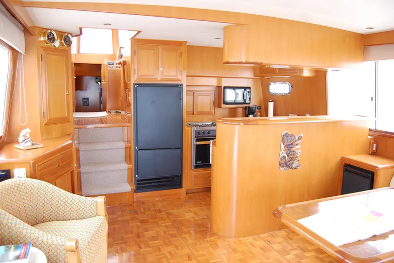 Slide: The Image of Interior of 2001 Ocean Alexander Classico yacht with wooden cabinetry and modern kitchen amenities. - 20