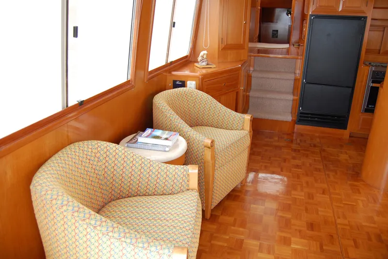 Slide: The Image of Interior of 2001 Ocean Alexander Classico yacht with cozy seating and wooden finishes. - 21