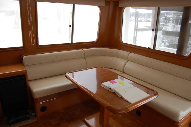 Slide: The Image of Luxurious interior of 2001 Ocean Alexander Classico yacht with leather seating and wooden table. - 22
