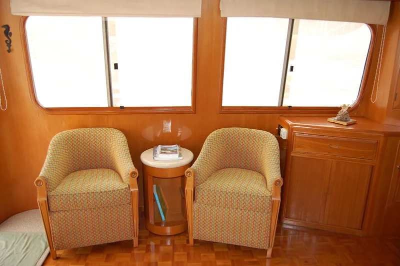 Slide: The Image of Interior of 2001 Ocean Alexander Classico yacht with two armchairs and a side table. - 24