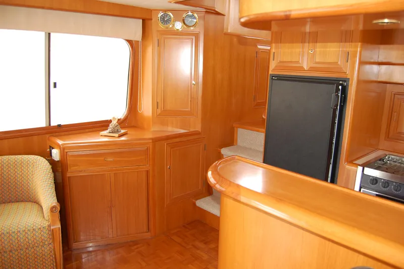 Slide: The Image of Interior of 2001 Ocean Alexander Classico yacht with wooden cabinetry and modern appliances. - 25