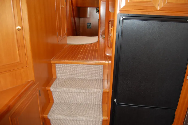 Slide: The Image of Interior of 2001 Ocean Alexander Classico yacht with wooden stairs and cabinetry. - 26