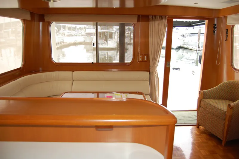 Slide: The Image of Luxurious interior of 2001 Ocean Alexander Classico yacht with elegant wood finishes and marina view. - 29