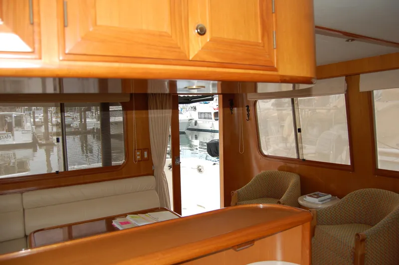 Slide: The Image of Interior of 2001 Ocean Alexander Classico yacht with wooden cabinetry and marina view. - 30