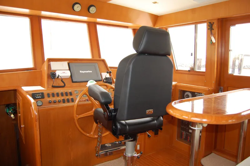Slide: The Image of Pilothouse of 2001 Ocean Alexander Classico yacht with steering wheel and navigation equipment. - 31