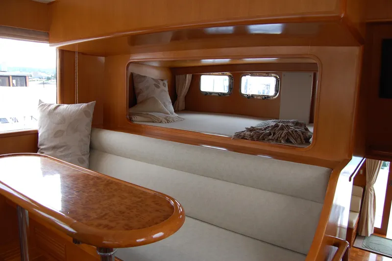 Slide: The Image of Luxurious interior of 2001 Ocean Alexander Classico yacht with elegant wood finish and cozy seating. - 32