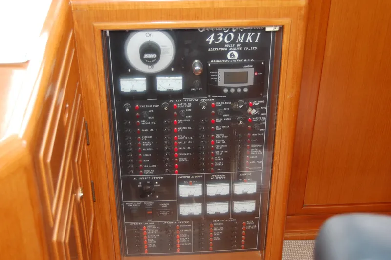 Slide: The Image of Control panel of a 2001 Ocean Alexander Classico yacht, featuring various switches and gauges. - 34