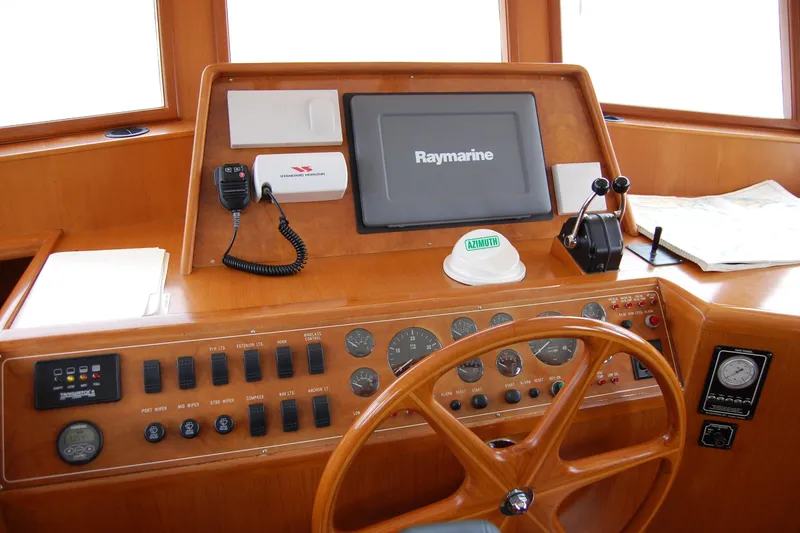 Slide: The Image of 2001 Ocean Alexander Classico helm with Raymarine display and navigation controls. - 35