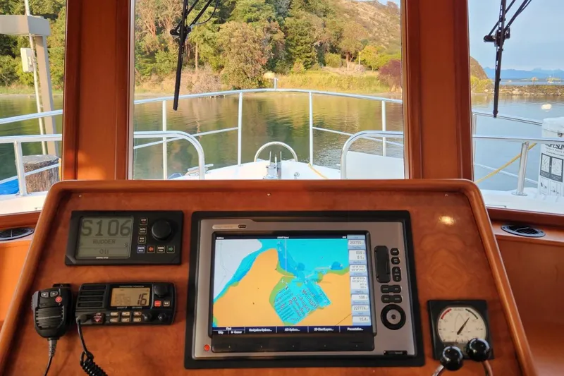 Slide: The Image of Cockpit view of 2001 Ocean Alexander Classico yacht with navigation equipment and scenic waterway. - 37