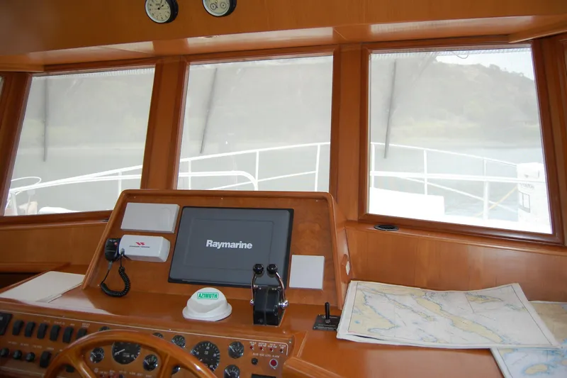 Slide: The Image of Pilothouse of 2001 Ocean Alexander Classico yacht with navigation equipment and sea charts. - 39