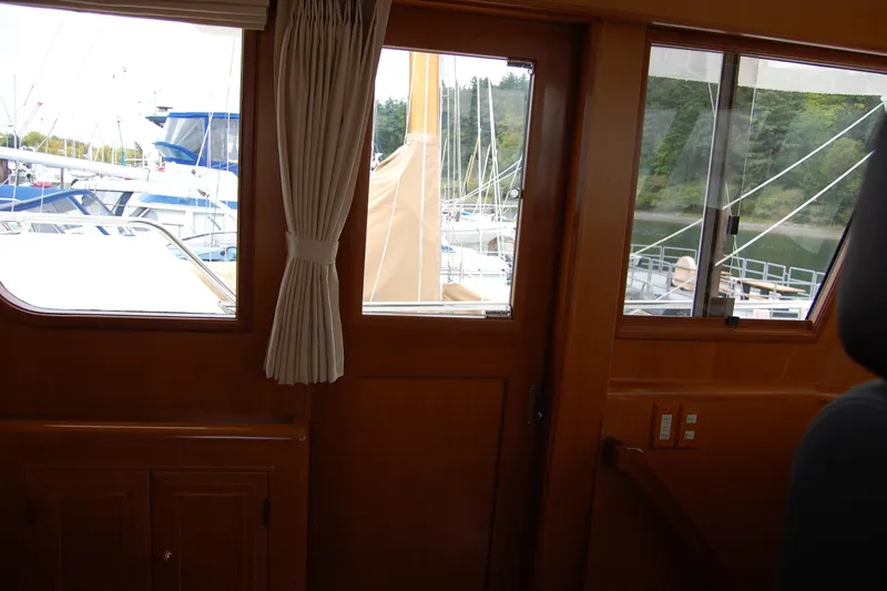 Slide: The Image of Interior view of 2001 Ocean Alexander Classico yacht with marina backdrop. - 44