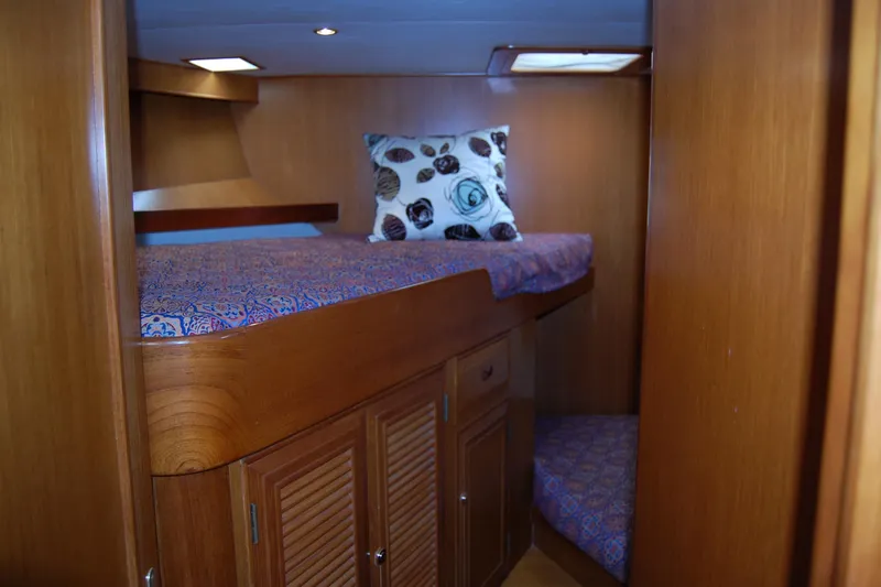 Slide: The Image of Cozy cabin interior of 2001 Ocean Alexander Classico yacht with wooden finish and patterned bedding. - 47