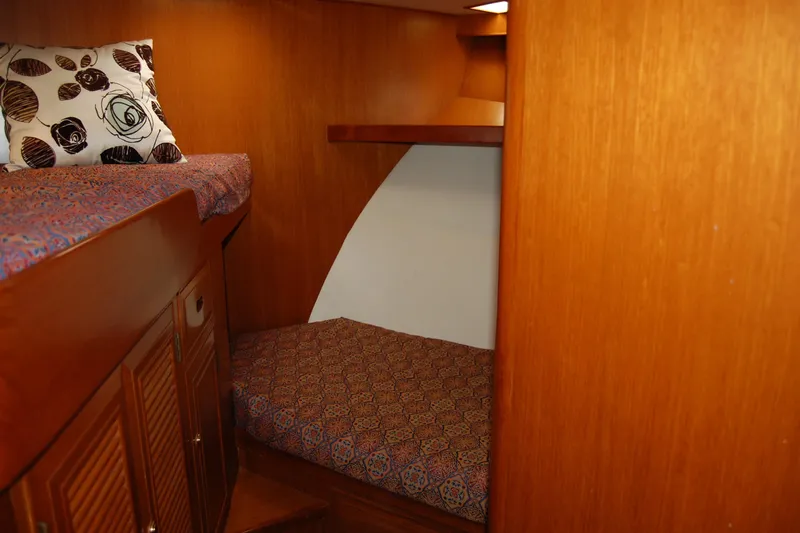 Slide: The Image of Cozy cabin interior of 2001 Ocean Alexander Classico yacht with wooden finish and patterned bedding. - 48