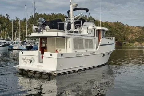 Slide: The Image of 2001 Ocean Alexander Classico yacht docked in a serene marina setting. - 5