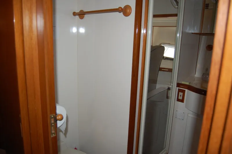 Slide: The Image of Interior of 2001 Ocean Alexander Classico yacht bathroom with wooden accents and mirror. - 50