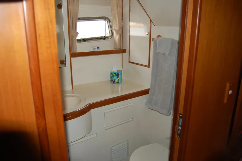 Slide: The Image of Bathroom interior of 2001 Ocean Alexander Classico yacht with wooden accents and window. - 51