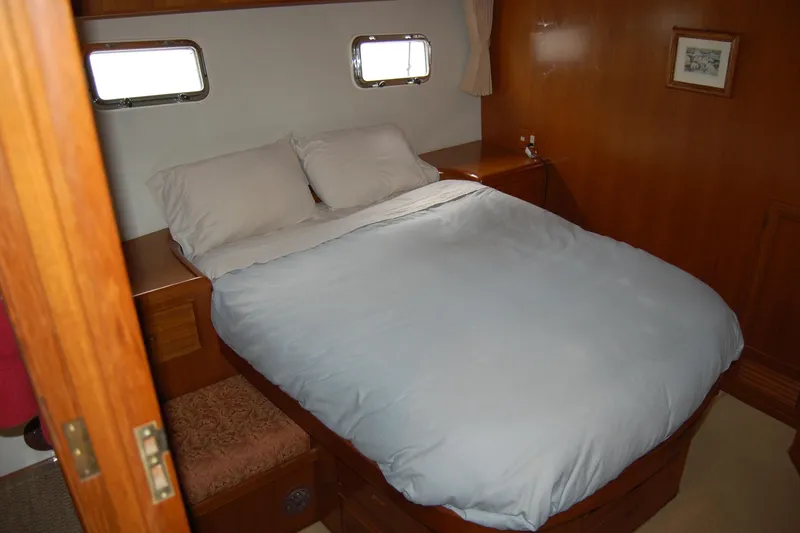 Slide: The Image of Cozy bedroom in 2001 Ocean Alexander Classico yacht with wooden interior and double bed. - 52