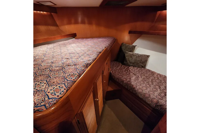 Slide: The Image of Cozy cabin interior of 2001 Ocean Alexander Classico yacht with patterned bedding. - 56