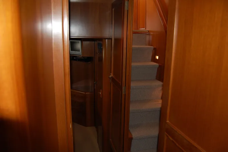 Slide: The Image of Interior of 2001 Ocean Alexander Classico yacht with wooden paneling and carpeted stairs. - 58