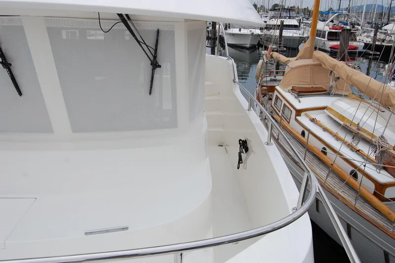 Slide: The Image of 2001 Ocean Alexander Classico yacht docked at marina, showcasing sleek design and spacious deck. - 64