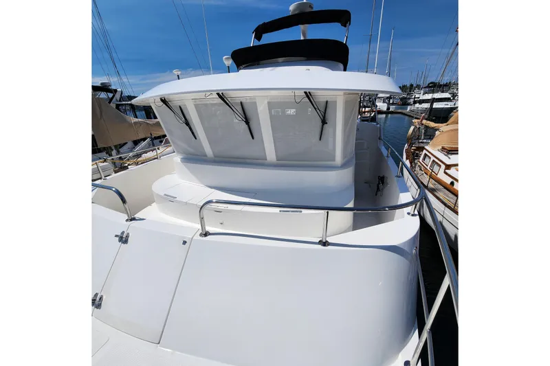 Slide: The Image of 2001 Ocean Alexander Classico yacht docked at marina, showcasing sleek white exterior. - 65