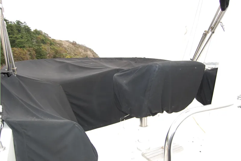 Slide: The Image of Covered seating area on 2001 Ocean Alexander Classico yacht, near rocky shoreline. - 68