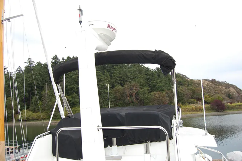 Slide: The Image of 2001 Ocean Alexander Classico yacht with radar, docked near forested shoreline. - 69