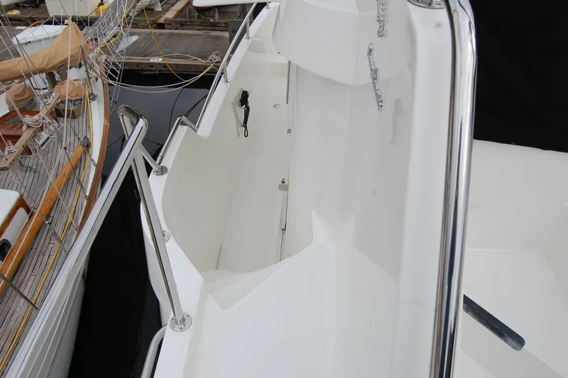Slide: The Image of 2001 Ocean Alexander Classico yacht deck with polished railings and clean white surface. - 71