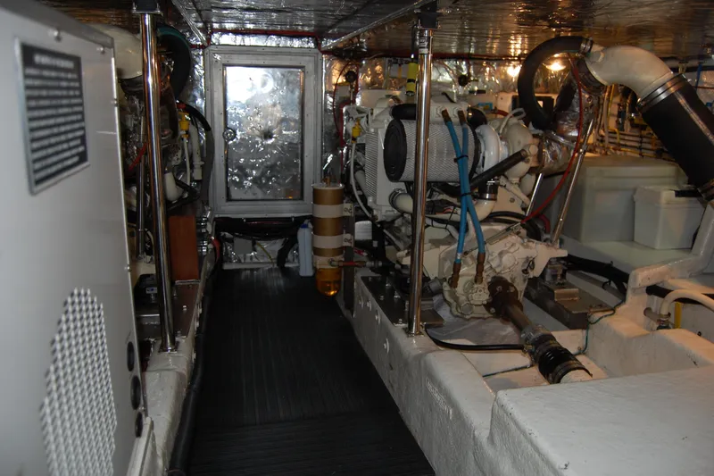 Slide: The Image of Engine room of 2001 Ocean Alexander Classico yacht, showcasing mechanical components and equipment. - 73
