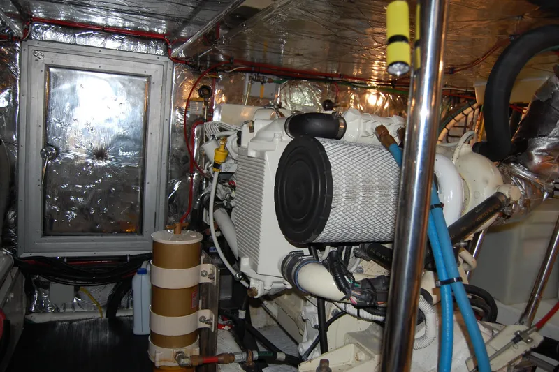 Slide: The Image of Engine room of 2001 Ocean Alexander Classico yacht, featuring machinery and insulation. - 76