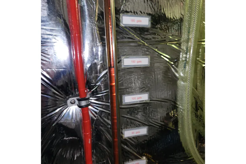 Slide: The Image of Engine room of 2001 Ocean Alexander Classico yacht with labeled fuel gauges. - 78