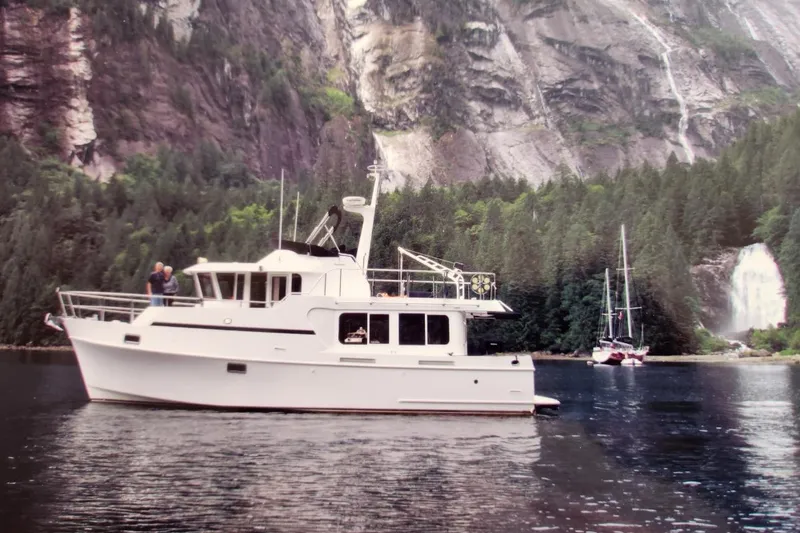 Slide: The Image of Ocean Alexander Classico 2001 yacht in scenic mountain and waterfall backdrop. - 82