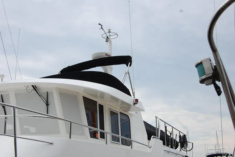 Slide: The Image of 2001 Ocean Alexander Classico yacht with radar and antennas against cloudy sky. - 9