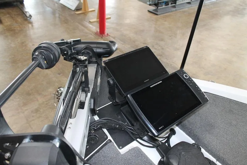 Slide: The Image of 2024 Phoenix 921 Elite II boat dashboard with dual electronic displays and steering controls. - 8