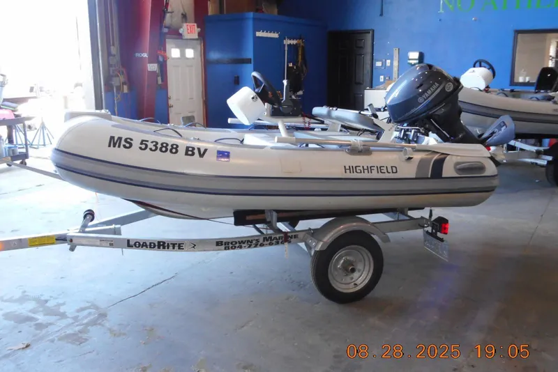 Slide: The Image of 2024 Highfield CL310 boat on trailer in a garage setting. - 3