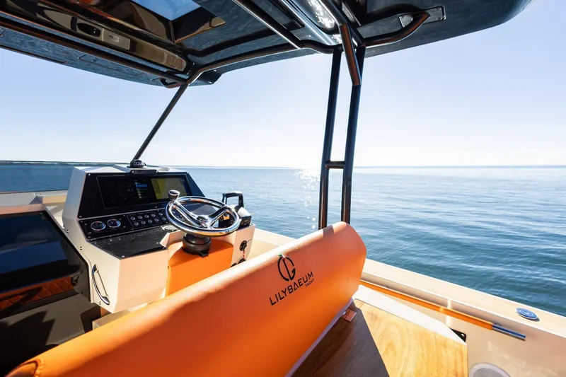 Slide: The Image of Modern AlCustom LIPARI 31 boat interior with steering wheel, overlooking calm sea, 2025 model. - 12