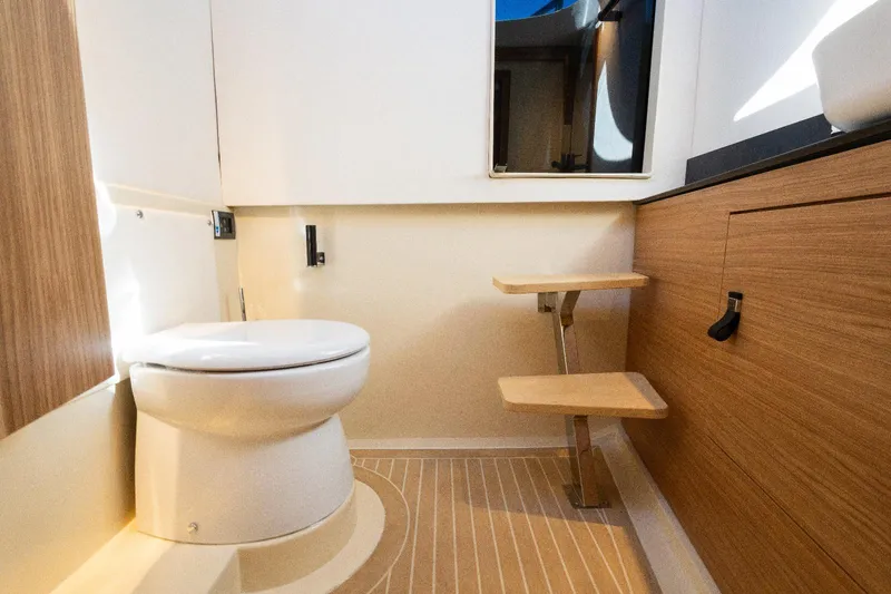 Slide: The Image of Modern bathroom interior in AlCustom LIPARI 31 yacht, 2025 model, featuring wood accents and sleek design. - 23