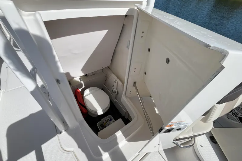 Slide: The Image of 2019 Robalo R222 Explorer boat interior with compact marine toilet. - 10